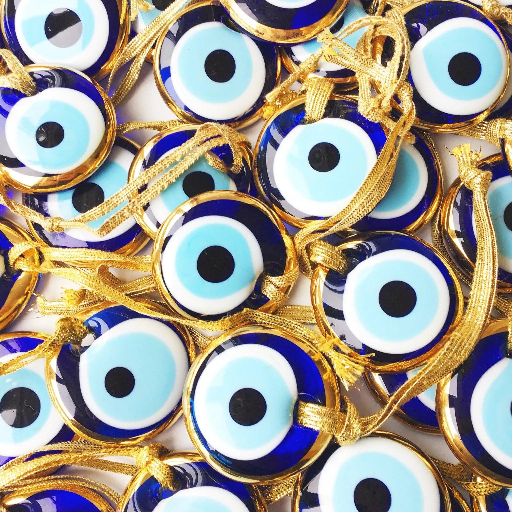 Gold trimmed glass evil eye beads with gold ropes